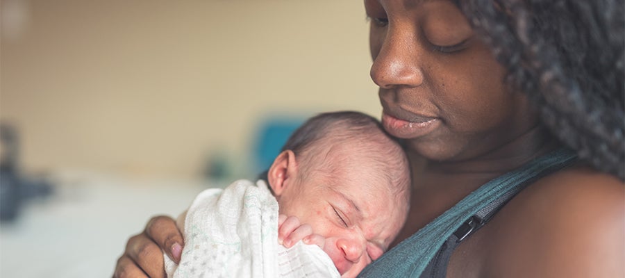 March for moms image- African American mother cradling newborn