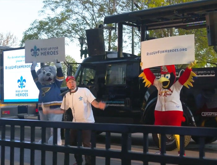 BJC Healthcare, Rise up for Heroes, both team mascots hold up signs