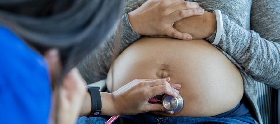 Image of stethoscope on woman's pregnant belly
